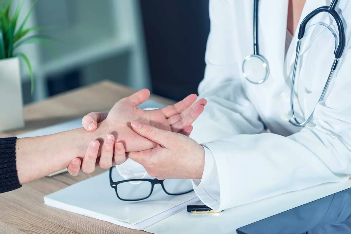 An orthopaedic surgeon examining a patient’s wrist